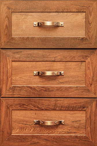 bronze drawer handles on three wooden drawers