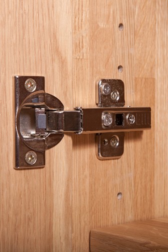 cupboard door hinge on a wooden cabinet