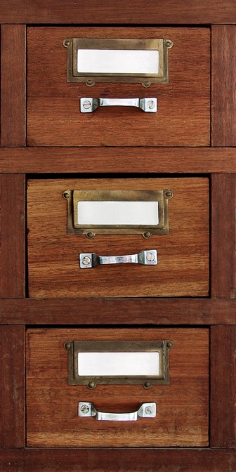 row of small drawers in an old furniture cabinet